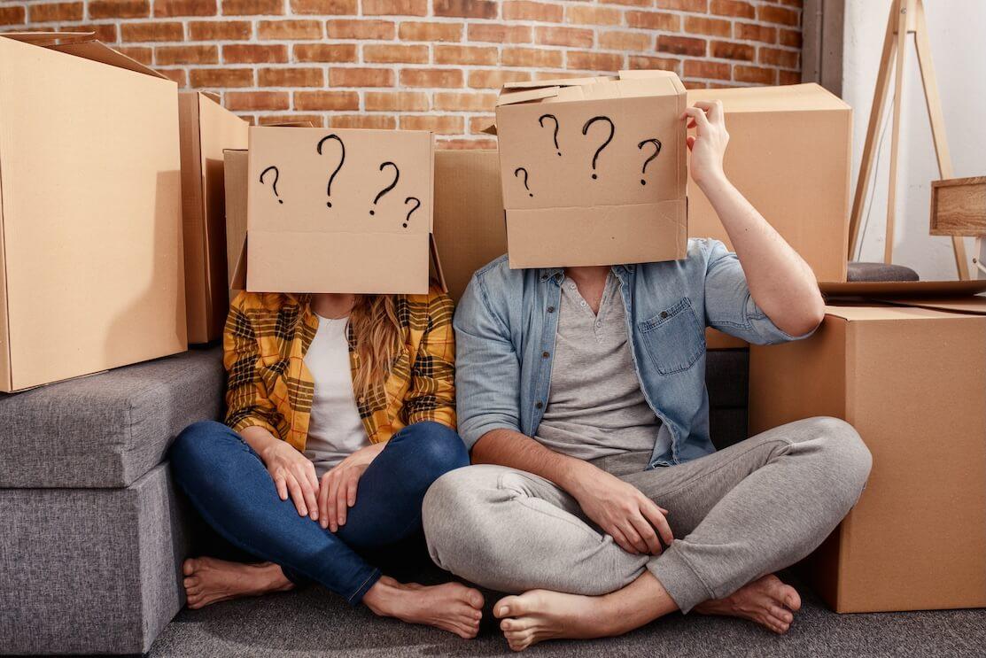 Problem Houses couple with boxes on their heads with question marks drawn on them